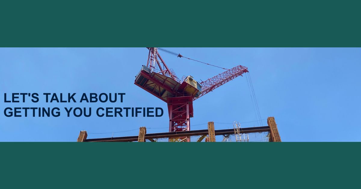 Red crane erecting structural steel against a blue sky, hoping to achieve AISC certification.